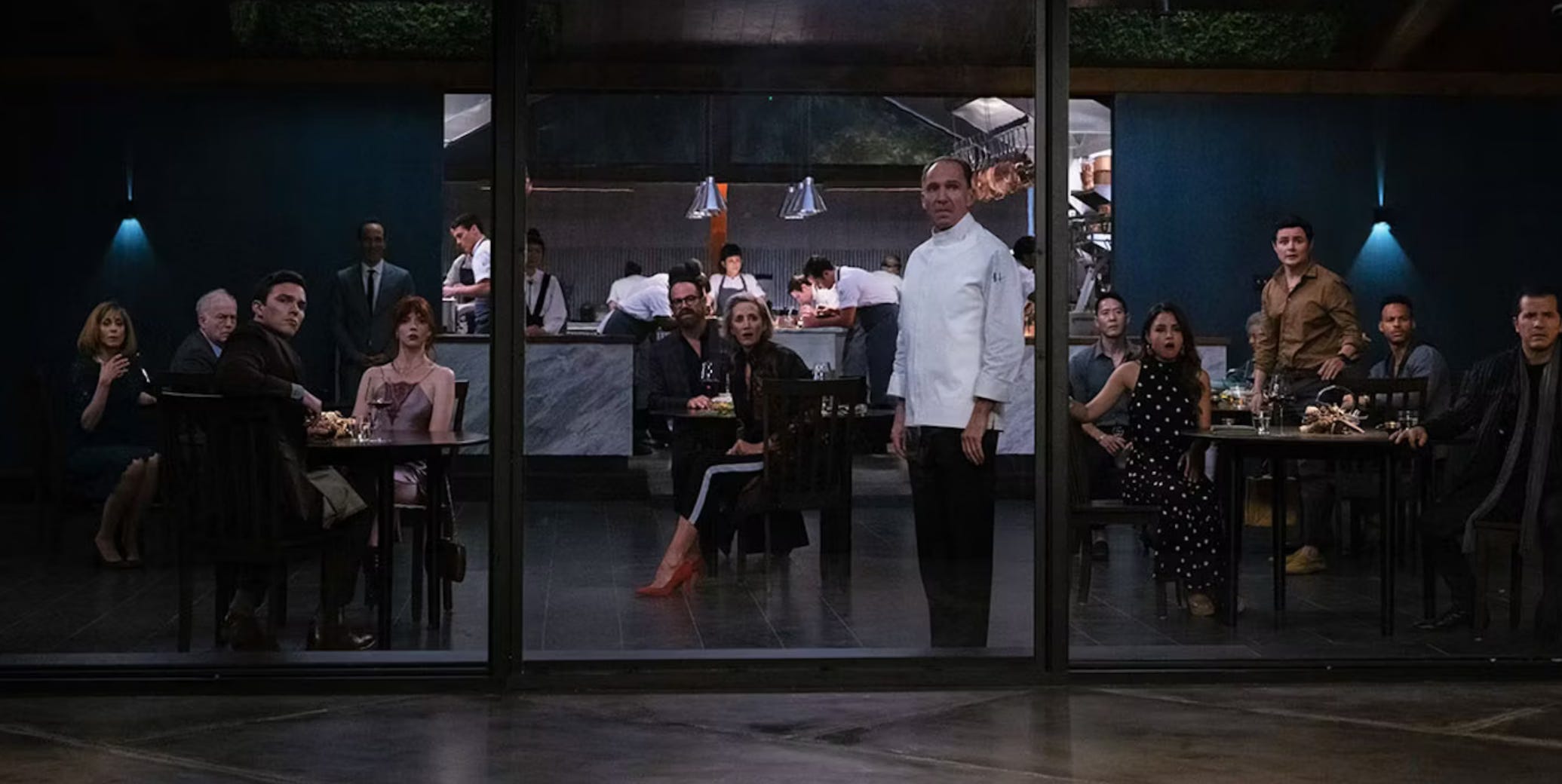 Chef and guests looking shocked by something happening outside